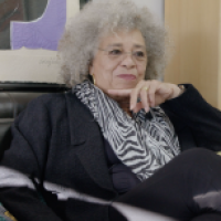 Angela Davis seated in home