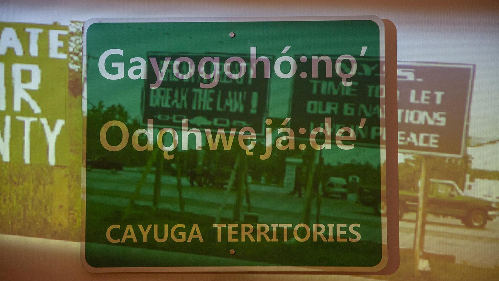 Jolene Rickard  Fight for the Line image of sign with Gayogoho:no Odohweja:de Cayuga Terrirtories