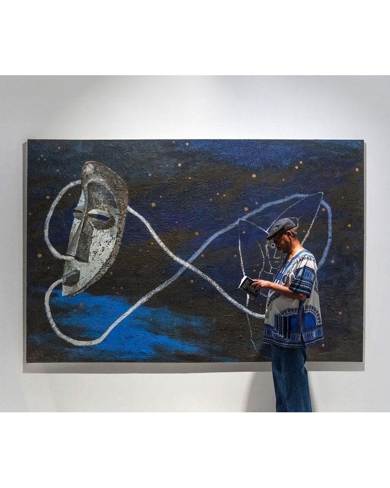 Artist Gavin Jantjes stands next to painting