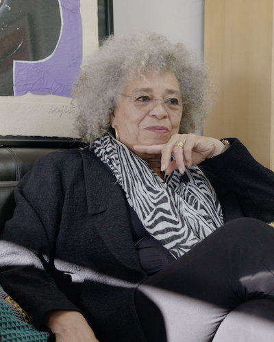 Angela Davis seated in home